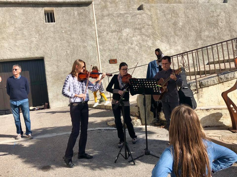 Le village de Lumiu recueilli autour de son monument aux morts Le village de Lumiu recueilli autour de son monument aux morts